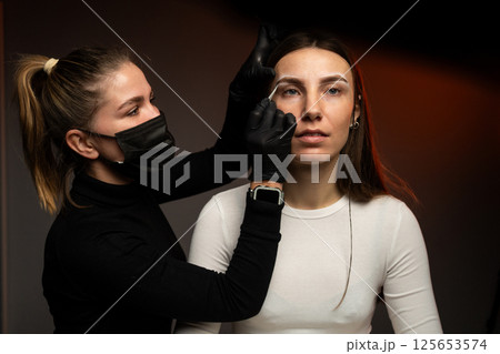 An engaging eyebrow styling session showcasing precision and artistry through innovative techniques 125653574
