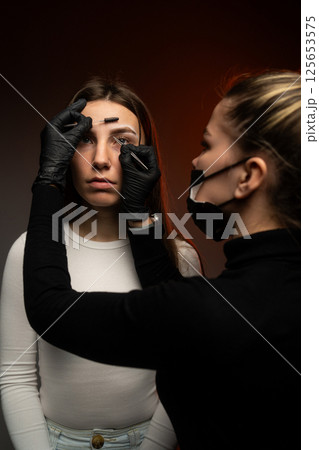 An engaging eyebrow styling session showcasing precision and artistry through innovative techniques 125653575