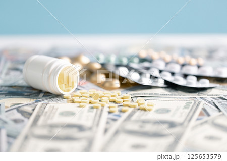 Medical business, a doctor carefully manages the money for each dose of medication, ensuring that even narcotic prescriptions are given against a backdrop of responsible health care. medicine, money. 125653579