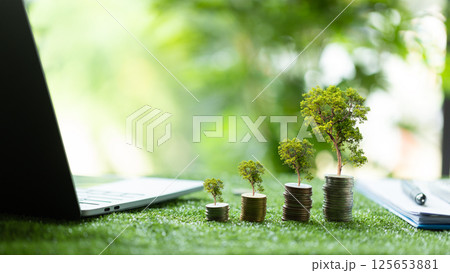 Concept of green finance flourishing businesses invest money and coins into sustainable ventures, nurturing growth of nature-friendly projects and ensuring prosperous future. green finance growth. 125653881