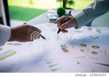 Business meeting on sustainable real estate development. real estate, sustainable development, business meeting, green building, eco-friendly, architecture, planning, construction, investment. 125654235