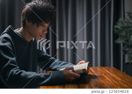 Person raised their hand in prayer at the church, embodying their Christian faith and belief in God, seeking hope and the holy presence of Christ through their devout religion. jesus christ, pray. 125654628