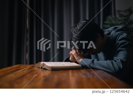 Person raised their hand in prayer at the church, embodying their Christian faith and belief in God, seeking hope and the holy presence of Christ through their devout religion. jesus christ, pray. Person raised their hand in prayer at the church, embodying their Christian faith and belief in God, seeking hope and the holy presence of Christ through their devout religion. jesus christ, pray. 125654642