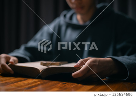 Person raised their hand in prayer at the church, embodying their Christian faith and belief in God, seeking hope and the holy presence of Christ through their devout religion. jesus christ, pray. Person raised their hand in prayer at the church, embodying their Christian faith and belief in God, seeking hope and the holy presence of Christ through their devout religion. jesus christ, pray. 125654696