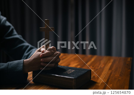 Person raised their hand in prayer at the church, embodying their Christian faith and belief in God, seeking hope and the holy presence of Christ through their devout religion. jesus christ, pray. Person raised their hand in prayer at the church, embodying their Christian faith and belief in God, seeking hope and the holy presence of Christ through their devout religion. jesus christ, pray. 125654870