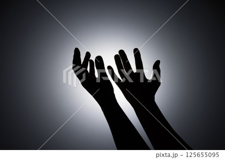 Silhouette photo, A young woman prayed for God's blessings with the power and holiness of God on white background. God and Spiritual Concepts. 125655095
