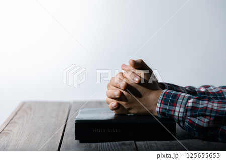 Christian life crisis prayer to god. Woman Pray for god blessing to wishing have a better life. woman hands praying to god with the bible. begging for forgiveness and believe in goodness. Christian life crisis prayer to god. Woman Pray for god blessing to wishing have a better life. woman hands praying to god with the bible. begging for forgiveness and believe in goodness. 125655653