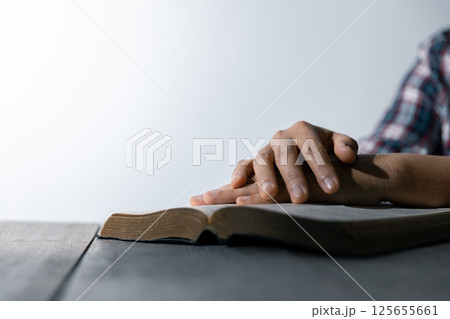 Christian life crisis prayer to god. Woman Pray for god blessing to wishing have a better life. woman hands praying to god with the bible. begging for forgiveness and believe in goodness. 125655661