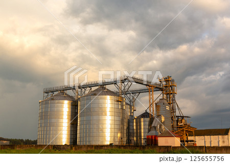 A captivating sunset over a grain dryer and hopper A captivating sunset over a grain dryer and hopper 125655756