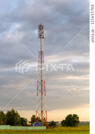 Sunset over rural farmland with cell tower 125655768