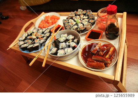 table with a set of rolls and sauce 125655989