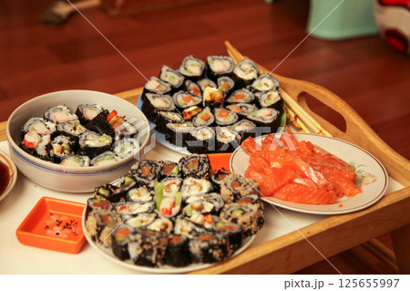 table with a set of rolls and sauce 125655997