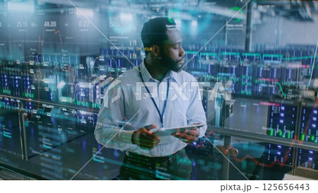 Futuristic Big Data Center with VFX: Administrator Using Digital Tablet Futuristic Big Data Center with VFX: Administrator Using Digital Tablet 125656443