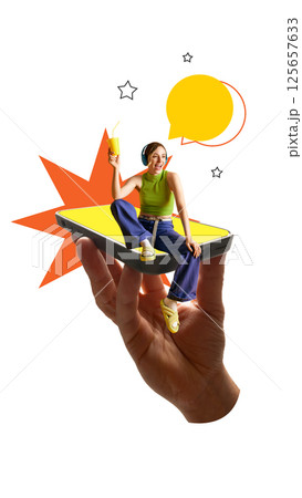 Joyful woman sitting on smartphone with drink and headphones smiles as stars and speech bubbles float. 125657633