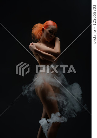 Captivating red-haired woman poses gracefully and confidently in nude setting Captivating red-haired woman poses gracefully and confidently in nude setting 125658803