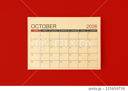 October 2026 desk calendar made from brown paper page on red background. 125659739