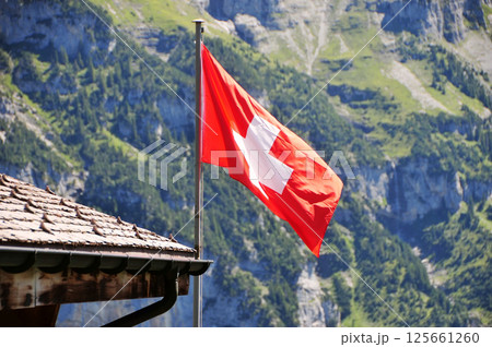Swiss flag flying on the roof Swiss flag flying on the roof 125661260