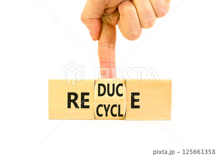 Reduce or recycle symbol. Concept words Reduce Recycle on wooden block. Beautiful white table white background. Businessman hand. Business reduce or recycle concept. Copy space. Reduce or recycle symbol. Concept words Reduce Recycle on wooden block. Beautiful white table white background. Businessman hand. Business reduce or recycle concept. Copy space. 125661358