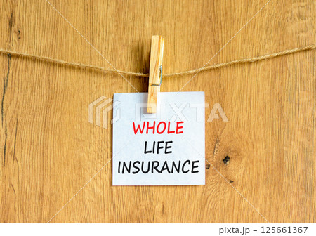 Whole life insurance symbol. Concept words Whole life insurance on beautiful white paper on clothespin. Beautiful wooden background. Business whole life insurance concept. Copy space. Whole life insurance symbol. Concept words Whole life insurance on beautiful white paper on clothespin. Beautiful wooden background. Business whole life insurance concept. Copy space. 125661367