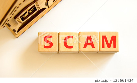 Scam symbol. Concept word Scam on beautiful wooden blocks. Beautiful wooden house. Beautiful white table white background. Business, lifestyle, support and scam concept. Copy space. Scam symbol. Concept word Scam on beautiful wooden blocks. Beautiful wooden house. Beautiful white table white background. Business, lifestyle, support and scam concept. Copy space. 125661434