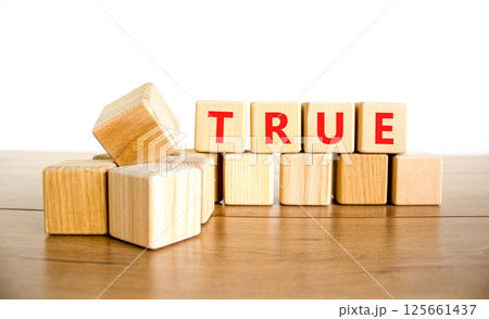 True symbol. Concept word True on beautiful wooden blocks. Beautiful wooden table white background. Business, lifestyle, support and true concept. Copy space. 125661437