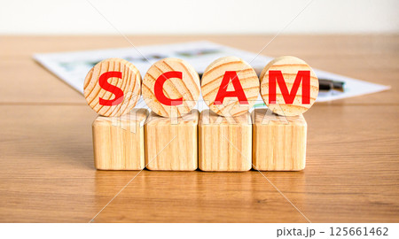 Scam symbol. Concept word Scam on beautiful wooden circles on wooden blocks. Beautiful wooden table white background. Business, lifestyle, support and scam concept. Copy space. Scam symbol. Concept word Scam on beautiful wooden circles on wooden blocks. Beautiful wooden table white background. Business, lifestyle, support and scam concept. Copy space. 125661462