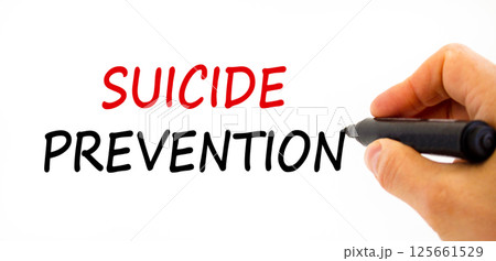 Suicide prevention symbol. Concept words Suicide prevention on beautiful white paper. Psychologist hand. Beautiful white paper background. Psychological and suicide prevention concept. Copy space. Suicide prevention symbol. Concept words Suicide prevention on beautiful white paper. Psychologist hand. Beautiful white paper background. Psychological and suicide prevention concept. Copy space. 125661529