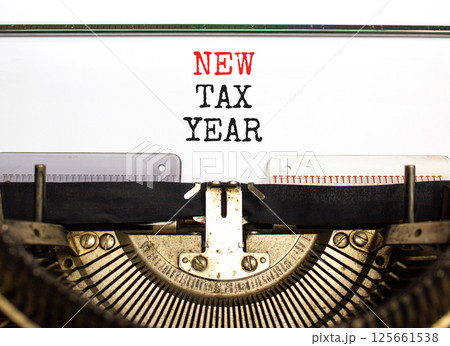 New tax year symbol. Concept words New tax year typed on beautiful old retro vintage typewriter. Beautiful white background. Business new tax year concept. Copy space. 125661538