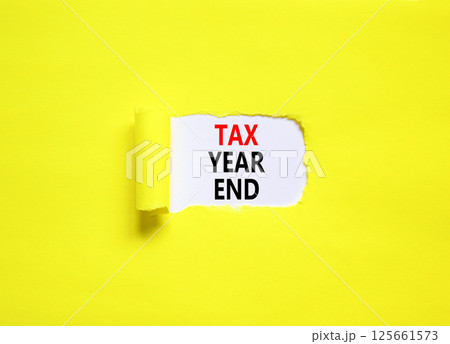 Tax year end symbol. Concept words Tax year end on beautiful white paper. Beautiful yellow table yellow background. Business tax year end concept. Copy space. Tax year end symbol. Concept words Tax year end on beautiful white paper. Beautiful yellow table yellow background. Business tax year end concept. Copy space. 125661573