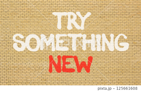 Try something new symbol. Concept words Try something new on beautiful brick wall . Beautiful brick wall background. Business motivational lifestyle try something new concept. Copy space. Try something new symbol. Concept words Try something new on beautiful brick wall . Beautiful brick wall background. Business motivational lifestyle try something new concept. Copy space. 125661608