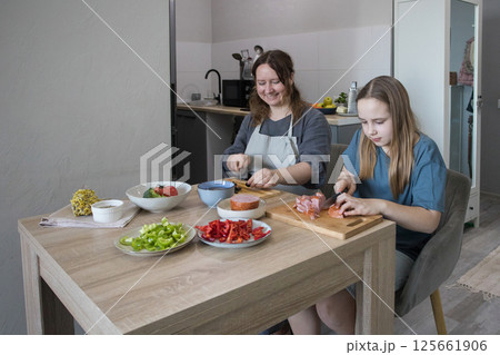 Happy smiling mother and loving child girl spending time together at home. Healthy meal  125661906