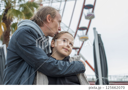Beautiful daughter child girl and her father walking outdoors. Happiness, childhood 125662070