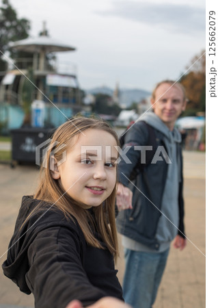 Cute daughter child girl and her father having fun. Happy family outdoors portrait. Cute daughter child girl and her father having fun. Happy family outdoors portrait. 125662079