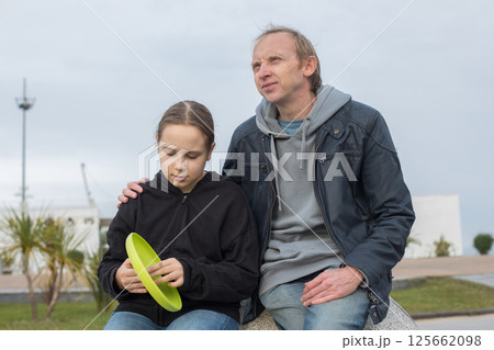 Father and daughter young girl in spring day outdoors. Happy family, childhood Father and daughter young girl in spring day outdoors. Happy family, childhood 125662098