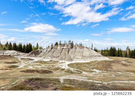 Waving trail among eroded hills in badlands in springtime. Waving trail among eroded hills in badlands in springtime. 125662238