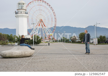 Cute daughter and father playing flying disc and having fun outdoors. Happy family, sport Cute daughter and father playing flying disc and having fun outdoors. Happy family, sport 125662547