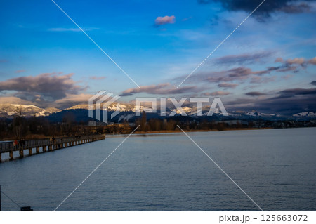 Golden hour magic on the jetty where the ocean breeze meets the colors of the setting sun Golden hour magic on the jetty where the ocean breeze meets the colors of the setting sun 125663072