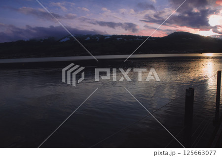 Blushed skies and still waters a pink sunset dream 125663077