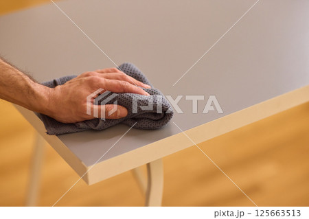 Performing the task of cleaning surfaces with a cloth for a fresh and polished look 125663513