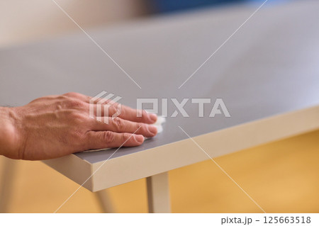 Performing the task of cleaning surfaces with a cloth for a fresh and polished look 125663518