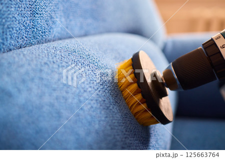 Effective Upholstery Cleaning Using a Power Tool on a Beautiful Sofa for the Best Results 125663764