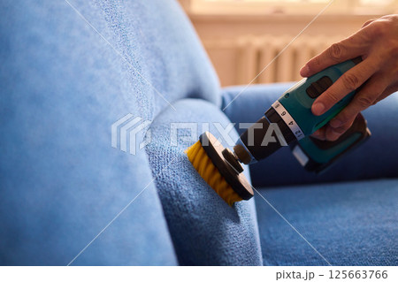 Effective Upholstery Cleaning Using a Power Tool on a Beautiful Sofa for the Best Results Effective Upholstery Cleaning Using a Power Tool on a Beautiful Sofa for the Best Results 125663766