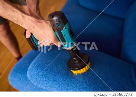 Effective Upholstery Cleaning Using a Power Tool on a Beautiful Sofa for the Best Results Effective Upholstery Cleaning Using a Power Tool on a Beautiful Sofa for the Best Results 125663772