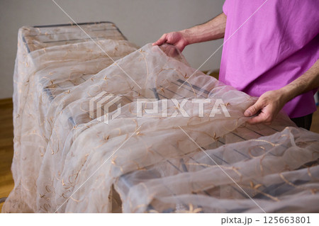 A Beautiful and Delicate Fabric Display Positioned on a Drying Rack for All to See A Beautiful and Delicate Fabric Display Positioned on a Drying Rack for All to See 125663801