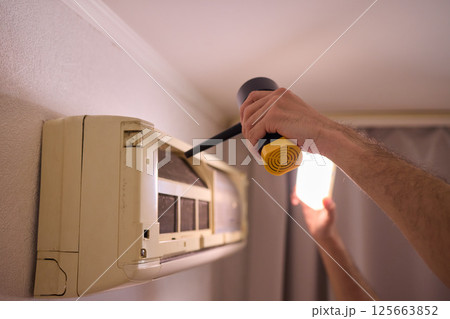 Hands are Actively Engaged in Various Tasks such as Air Conditioning Repair and Ongoing Maintenance Hands are Actively Engaged in Various Tasks such as Air Conditioning Repair and Ongoing Maintenance 125663852