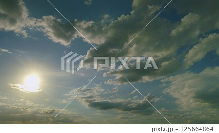 A Majestic Cloudy Sky Enhanced by Soft Sunlight Brightly Shining Through the Clouds A Majestic Cloudy Sky Enhanced by Soft Sunlight Brightly Shining Through the Clouds 125664864