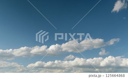 A Serene and Cloudy Sky Painting with a Bright Blue Background and Fluffy White Clouds A Serene and Cloudy Sky Painting with a Bright Blue Background and Fluffy White Clouds 125664868