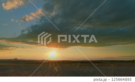 A Breathtaking and Stunning Sunset Over the Horizon, Accompanied by Dramatic and Beautiful Clouds 125664893