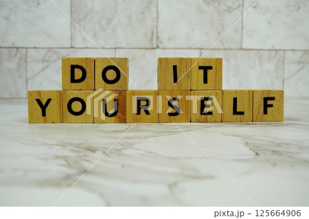 Do It Yourself with wooden blocks alphabet letters on marble background 125664906