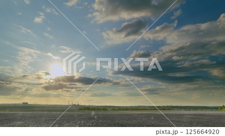A Beautiful and Scenic Sunrise Over an Expansive Open Landscape Surrounded by Dramatic Clouds A Beautiful and Scenic Sunrise Over an Expansive Open Landscape Surrounded by Dramatic Clouds 125664920